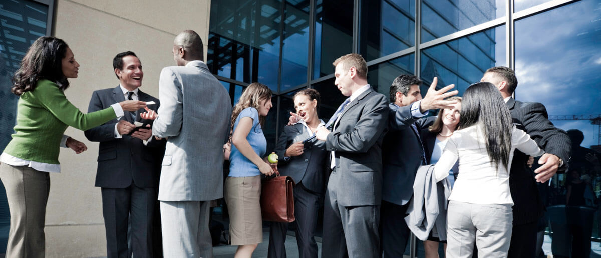 stakeholders standing out of a bulding and having random discussion with each other